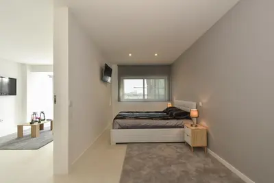 a bedroom with a bed and a window at Downtown Prime Porto in Porto