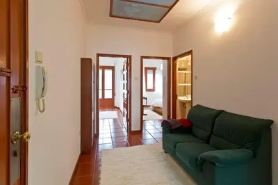 a living room with a green couch in a room at Camarao Apartment in Porto