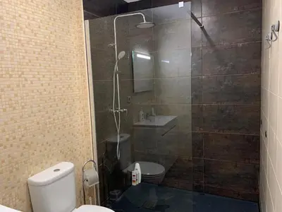 a bathroom with a shower with a toilet and a sink at Campanhã Boutique Station in Porto