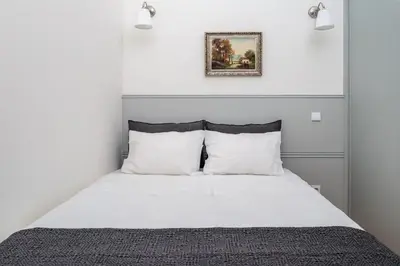 a bedroom with a white bed with white pillows at AmaOporto - St. Ildefonso in Porto