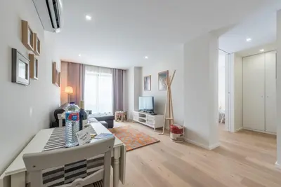 a living room with a table and a television at GuestReady - Gemini Apartment in Porto
