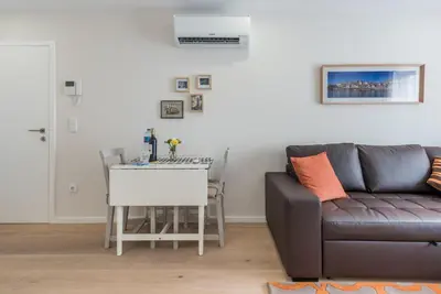 a living room with a couch and a flat screen tv at GuestReady - Gemini Apartment in Porto