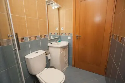 a bathroom with a toilet and a sink at ML Formosa Deluxe Rooms in Porto