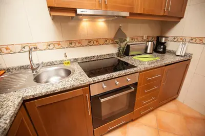 a small kitchen with a sink and a counter top at ML Formosa Deluxe Rooms in Porto