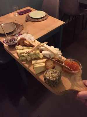 a table with a tray of cheese and other foods at Laurear Guest House in Porto