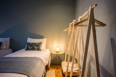 a bedroom with a bed and a bed frame at Laurear Guest House in Porto
