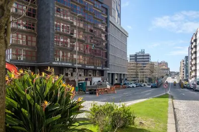 a city street with tall buildings and a parking lot at GuestReady - Back to Little World in Porto