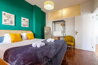 a bedroom with a large bed with towels on it at GuestReady - Back to Little World in Porto