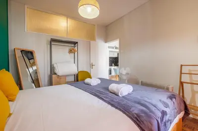 a bedroom with a large bed with two towels at GuestReady - Back to Little World in Porto