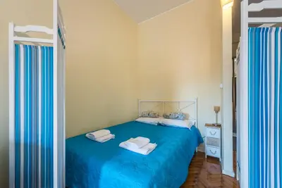 a bedroom with a blue bed with towels on it at GuestReady - Minimalistic studio downtown in Porto