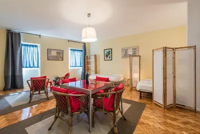 a living room with a table and chairs at GuestReady - Minimalistic studio downtown in Porto