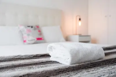 a white towel sitting on top of a bed at GuestReady - Cosy spot near Porto city centre in Porto