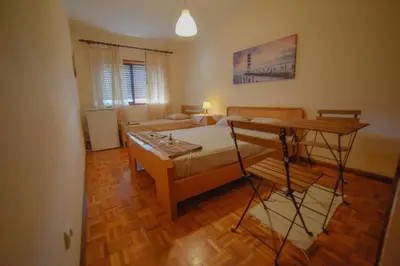 a room with a bed and a table in it at Quarto com 4 camas (Beliches+ 1 Sofá-cama) in Porto