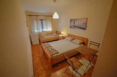 a bedroom with a bed and a table with chairs at Quarto com 4 camas (Beliches+ 1 Sofá-cama) in Porto