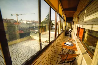 an empty balcony with a view of a patio at Quarto com 4 camas (Beliches+ 1 Sofá-cama) in Porto