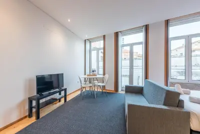 a living room with a couch and a tv at GuestReady - Given to fly in Porto