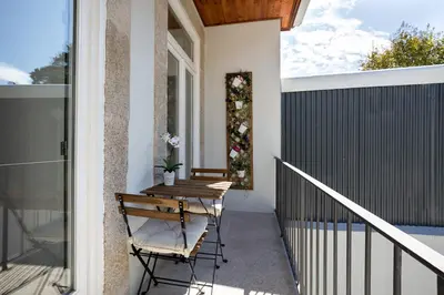 a patio with a table and chairs on a balcony at Almada Studio 419 in Porto