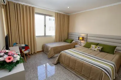 a hotel room with two beds and a window at Oporto City Centre Apartments in Porto