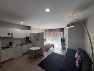 a room with a kitchen and a living room at ML Apartments Almada panoramic balcony in Porto