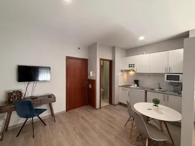 a small kitchen with a table and chairs in a room at ML Apartments Almada panoramic balcony in Porto