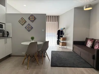 a living room with a couch and a table at ML Apartments Almada panoramic balcony in Porto