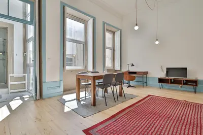a living room with a table and chairs and a television at Adorable Apartments in Great Area in Porto