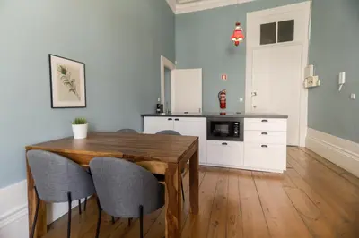 a kitchen with a wooden table and chairs at Adorable Apartments in Great Area in Porto