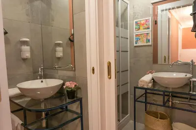 a bathroom with two sinks and a mirror at Oporto Centre Clean & Cozy Apt 2 in Porto