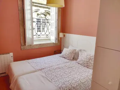 a bedroom with a white bed and a window at Oporto Center Clean & Cozy Apt 4th floor in Porto