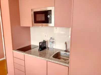 a kitchen with a sink and a microwave at Oporto Center Clean & Cozy Apt 4th floor in Porto