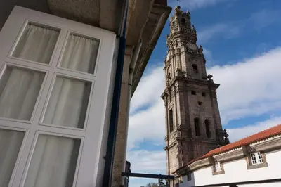 a building with a window and a clock tower at Oporto Center Clean & Cozy Apt 4th floor in Porto