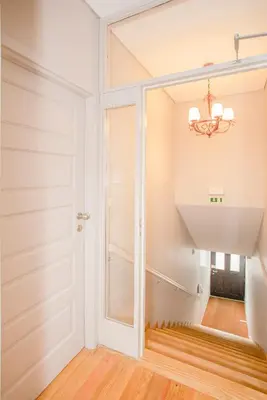 a room with a door and a chandelier at Liiiving in Porto - Historic Clérigos Apartments in Porto