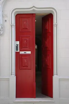 an open red door in a white building at Loft Mártires in Porto
