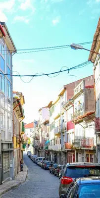 a city street with cars parked on the street at Bluetile Sol Apartment in Porto