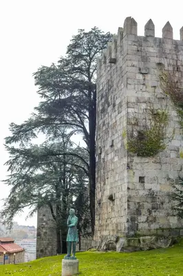 a statue of a woman in front of a castle at Bluetile Sol Apartment in Porto