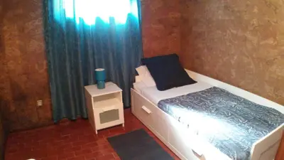 a small bedroom with a bed and a window at Silver Porto - AL in Porto