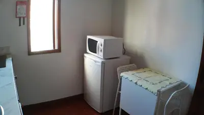 a microwave sitting on top of a refrigerator at Silver Porto - AL in Porto