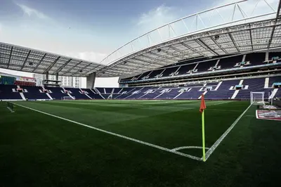 a stadium with a soccer field with blue seats at Silver Porto - AL in Porto