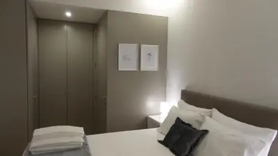 a bedroom with a bed with a large mirror at Porto Tropical Charm in Porto