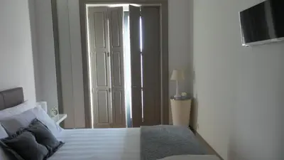 a bedroom with a bed and a sliding glass door at Porto Tropical Charm in Porto