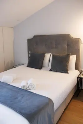 a bedroom with a large bed with two towels on it at Porto Views & Wines by Porto City Hosts in Vila Nova de Gaia
