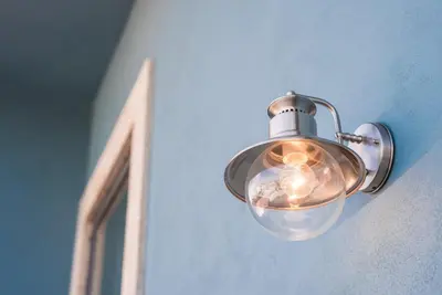 a light on the side of a wall at GuestReady - Modern stay in downtown Porto in Porto