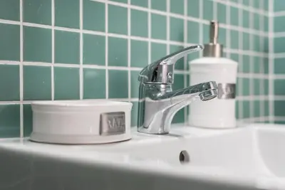 a bathroom sink with a faucet and a toothbrush at GuestReady - Modern stay in downtown Porto in Porto