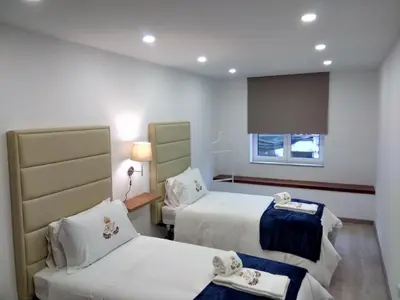 a hotel room with two beds and a window at ML Apartments Central Aliados in Porto