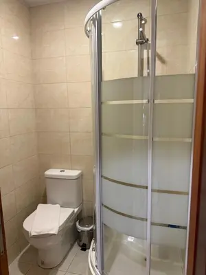 a bathroom with a toilet and a glass shower at ML Apartments Central Aliados in Porto