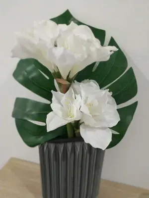 a grey vase with white flowers in it at ML Apartments Central Aliados in Porto