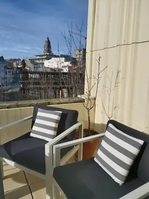 two chairs on a balcony with a view of a city at Porto Terrace Apartment in Porto