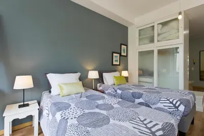 a bedroom with two beds with blue walls at Porto Terrace Apartment in Porto