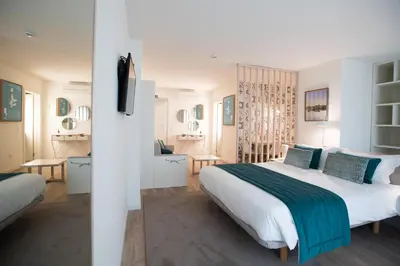 a bedroom with a large bed and a living room at Almada Wine House - Tourism Apartments in Porto
