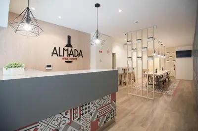 a lobby of a building with a table and chairs at Almada Wine House - Tourism Apartments in Porto